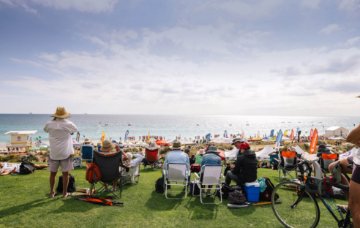 Image of visitors of Scarborough Beaching sitting on Sunset Hill